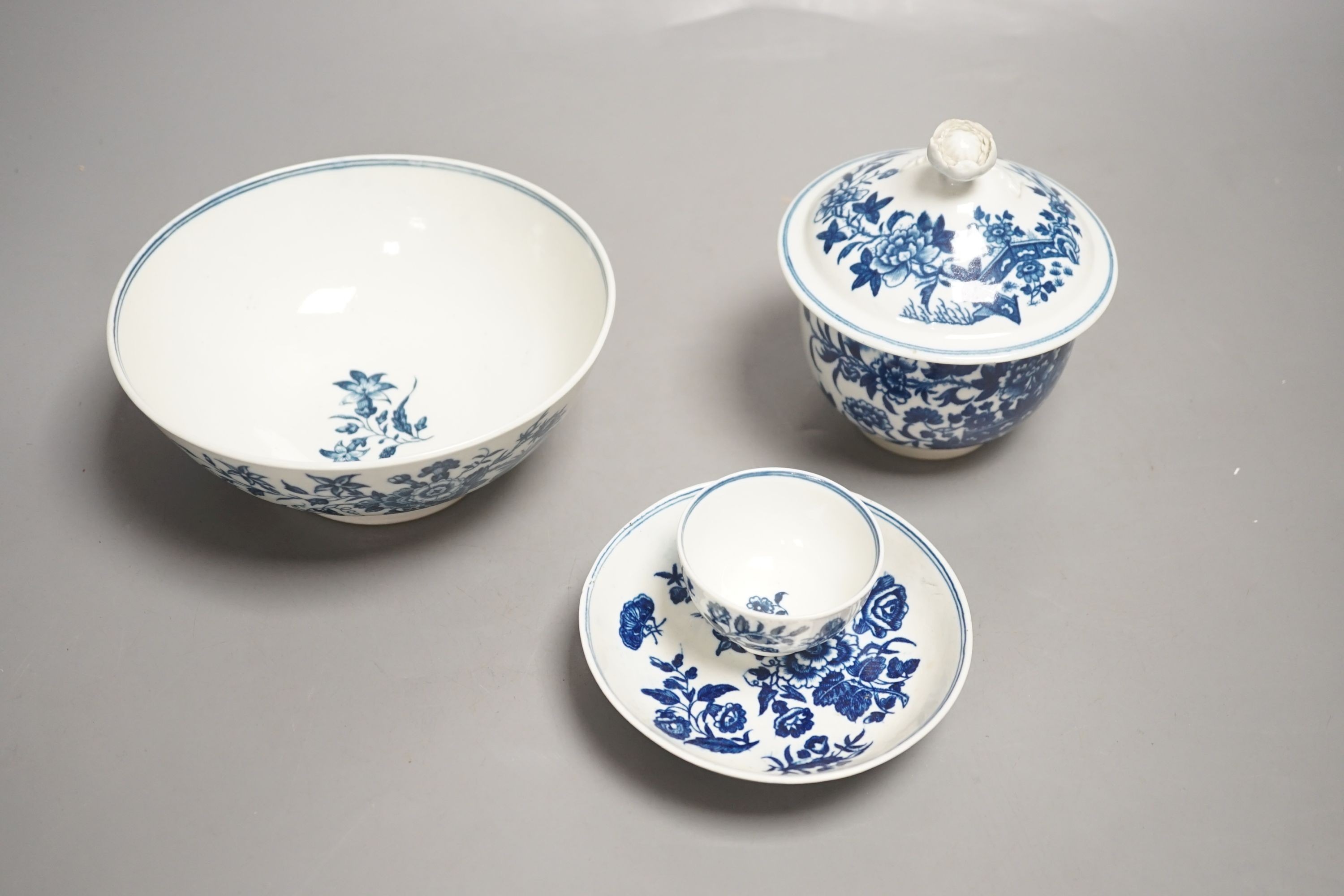 A Worcester sucrier and cover with floral finial printed in blue underglaze with the Fence pattern, Worcester toy size teabowl and saucer, and a Worcester bowl printed with the Three Flowers pattern c.1775-sucrier and co